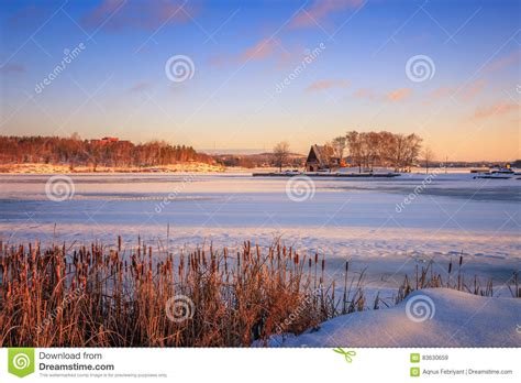 View Of A Frozen Lake During Sunrise In Winter Season Stock Image