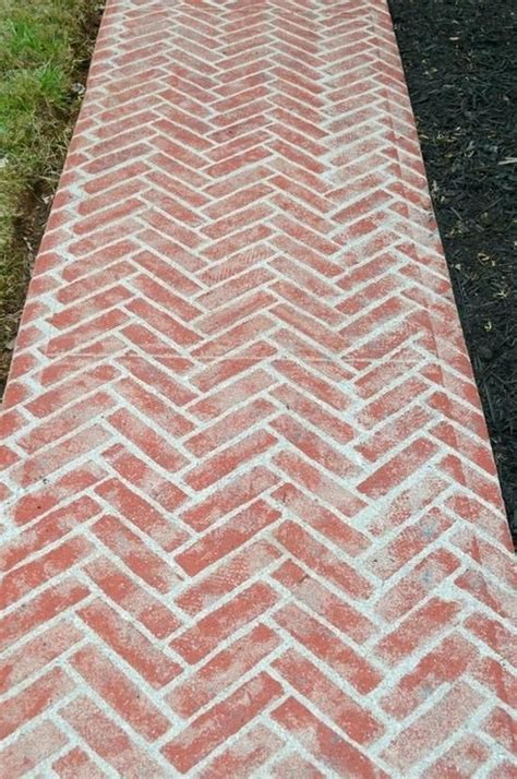 A Brick Walkway With Grass In The Background