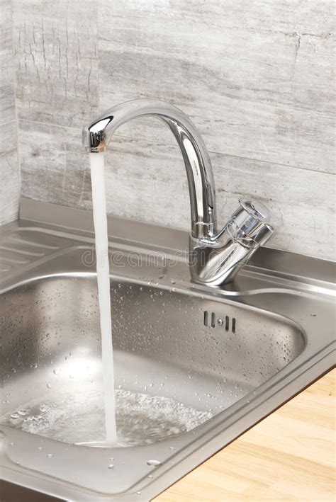 When your sink stinks, you probably try to avoid your kitchen. Kitchen Sink With Running Tap Water Stock Image - Image of ...