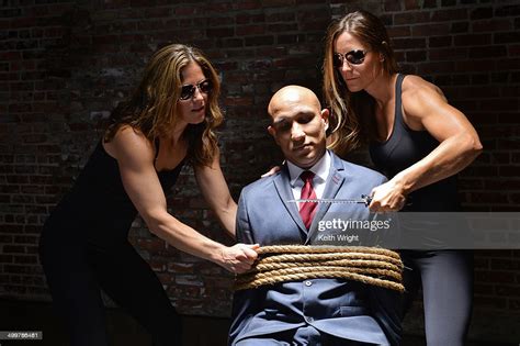 man tied up by 2 strong women bildbanksbilder getty images
