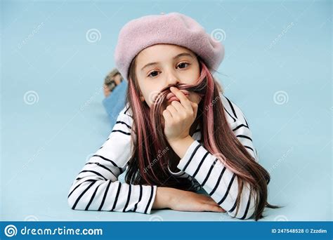 Silly Tween Girl In French Beret Making Mustache With Her Hair Stock