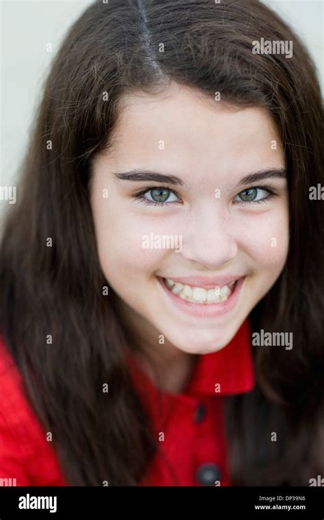Close Up Portrait Of Pre Teen Girl With Long Brown Hair Smiling And