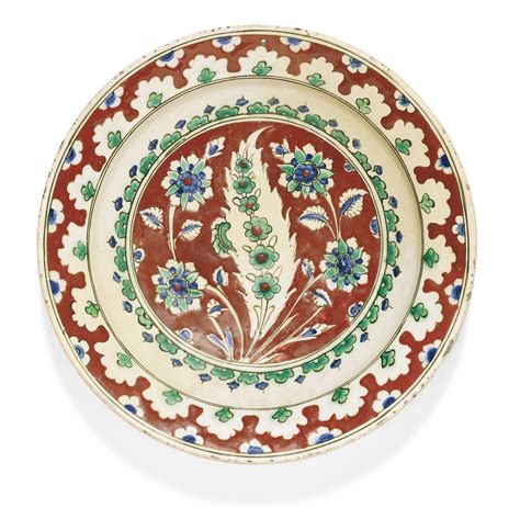 An Iznik Polychrome Pottery Dish With A Red Ground Turkey Circa