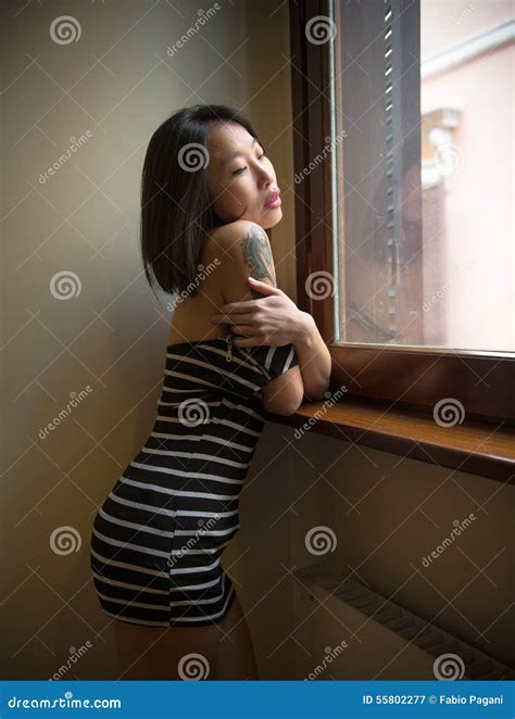 Beautiful Sensual Asian Woman Posing Thoughtful At Window Stock Image Image Of Reflective