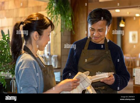 Couple Wiping Dishes At Counter Stock Photo Alamy
