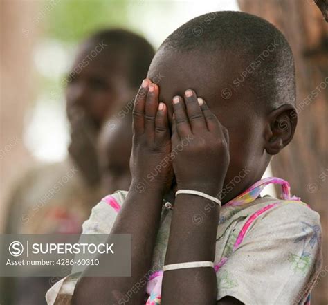A Girl In Rumbek South Sudan Plays Peek A Boo Not Model Released