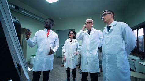 Four Scientists In White Lab Coats Standing Stock Footage SBV 313874886