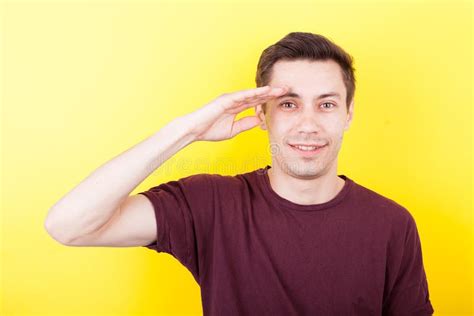 Man With His Hand To The Forehead Making The Army Salute Sign Stock