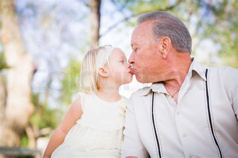Grandfather And Granddaughter Kissing At The Park Stock Image Colourbox