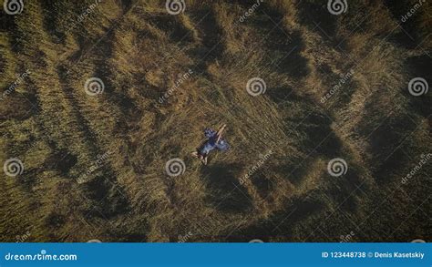 Aerial Attractive Girl In A Rustic Dress Lies In The Hayloft Young