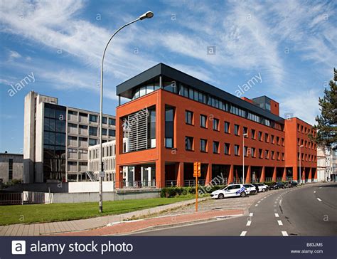 Modern Red Brick Building With Parking Area For Cars At