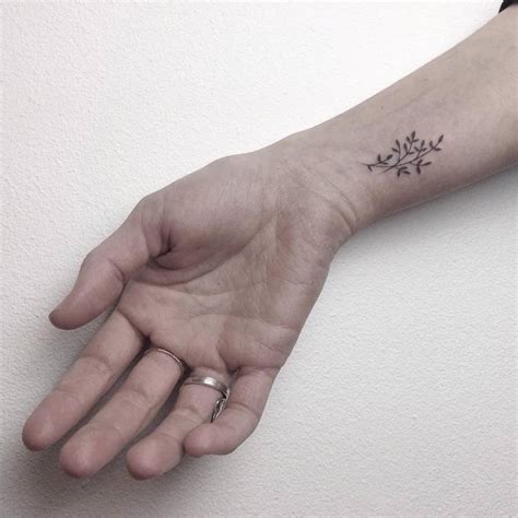 Small Flower Tattoo On The Right Inner Wrist