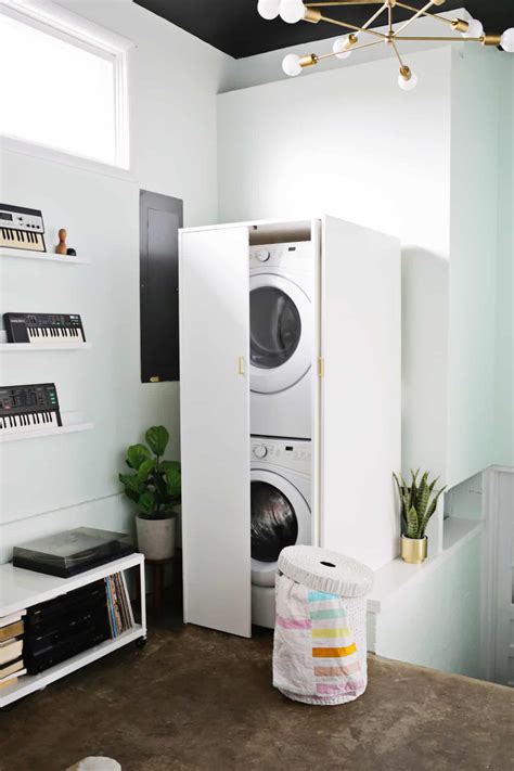 If you have a stacked washer and dryer set, design your cabinet to cover both of them, with one large door that can be opened to reveal the front of both. Hidden Washer and Dryer Cabinet | A Beautiful Mess ...