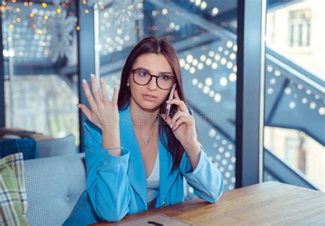 unhappy woman talking at phone frustrated hand in air stock image image of glasses dark