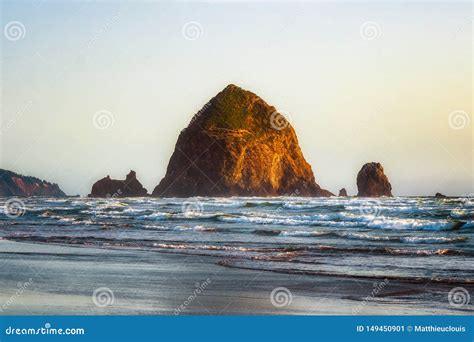 The Haystack Rock Sea Stack At High Tide At Sunset Natural Iconic