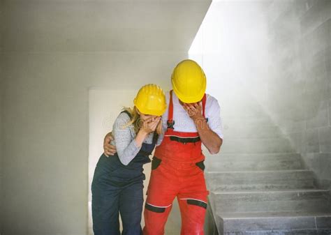 Woman And Man Workers Suffocating At The Construction Site Stock Image