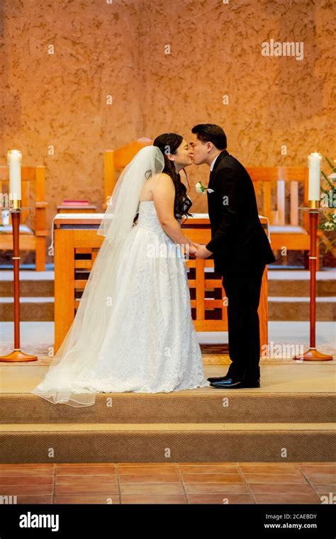 A Just Married Bride And Bridegroom Kiss At The Altar Of A Southern