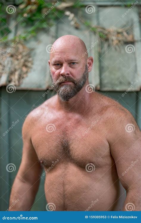 Bald Mature Muscular Black Man Portrait Arms Crossed In Front Of A My