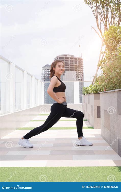 Healthy Young Woman Stretching Before Fitness And Exercise Stock Photo