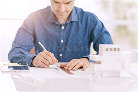 Professional Architect Working At Office Desk He Is Drawing With A