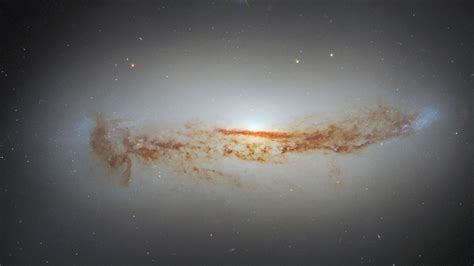 New Hubble Photo Shows Galaxys Bright Supermassive Black Hole Cloaked