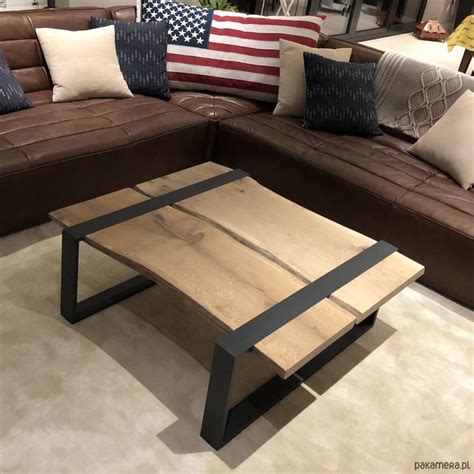 A Couch And Table In A Room With American Flags On The Wall Behind It