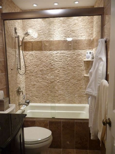 It's faced with the same engineered quartz as the counter top and the hinged glass door allows for the beautiful glass tile and niche to be appreciated. Tub Shower Combo tile Ideas | Visit diy.roomzaar.com ...