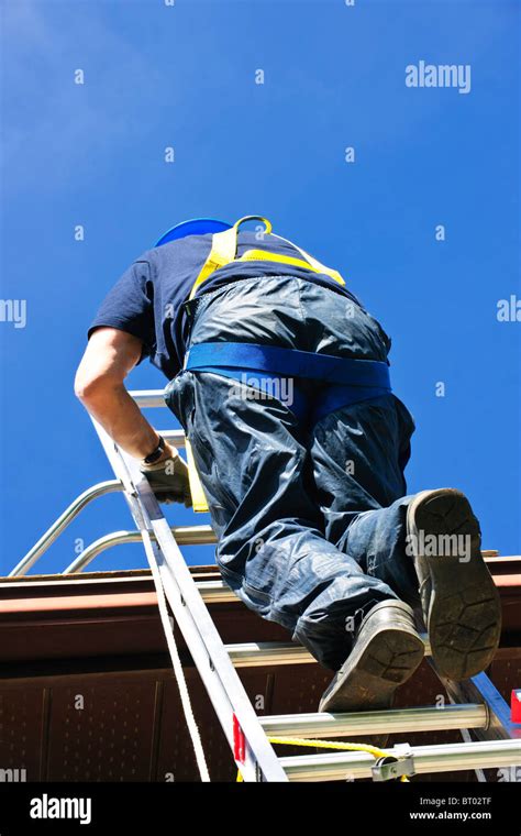 Construction Worker Climbing Extension Ladder To Roof Stock Photo Alamy