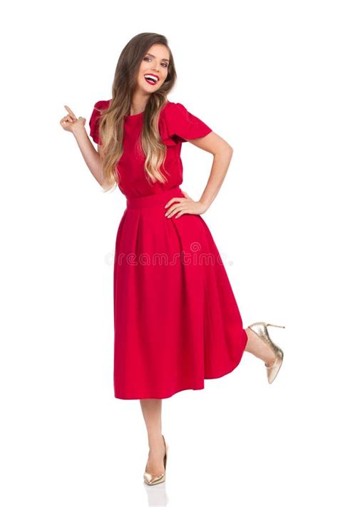 Laughing Beautiful Young Woman In Red Dress And High Heels Is Standing