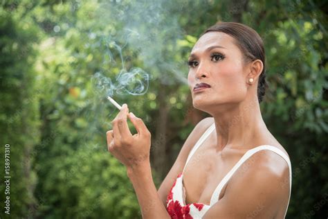 Portrait Of Asian Transwoman Or Transgender Smoking Cigarette In Garden