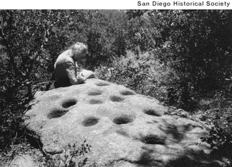 Anna May Davis Inspecting Mortar Holes In A Boulder At Silver Crest On