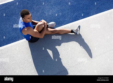 Runner Stretching On Track Stock Photo Alamy