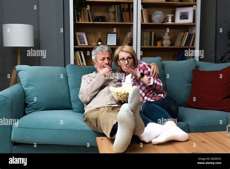 mature married couple entertaining observing terrified tv program senior people watching horror