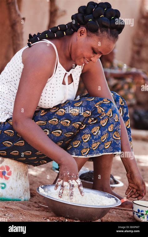 A Fulani Woman In The Town Of Djibo In Northern Burkina Faso Kneads
