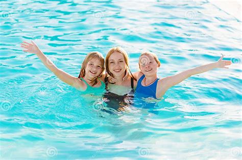 Mom Swims In The Pool With Her Two Daughters Stock Photo Image Of
