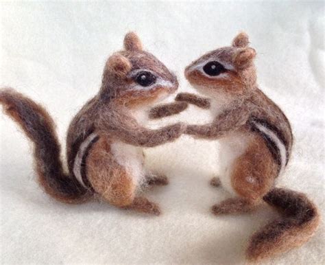 Two Needle Felt Squirrels Standing On Their Hind Legs And Touching