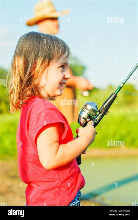 Little Girl Fishing With Rod And Reel At Pond Stock Photo Alamy