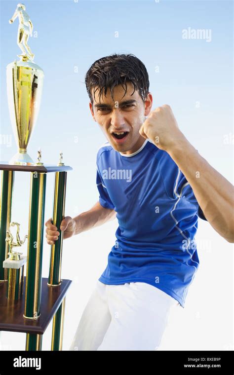 Football Player Holding Trophy Stock Photo Alamy