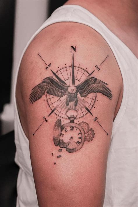 A Man With A Tattoo On His Arm Has An Eagle And Compass In The Background