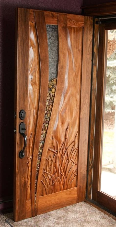 It is complemented by sleek planters and on the other hand those at the door can see inside your home. Custom-made walnut entry door: glass with river rocks ...