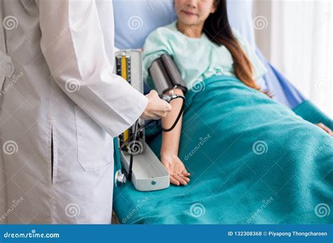 Doctor Woman Checking To Her Patient Blood Pressure In Hospitalheart