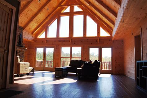 High cathedral ceilings and large windows give the living room of this