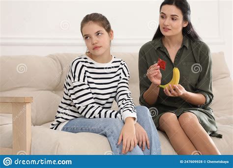 mother talking with her teenage daughter about contraception at home sex education concept