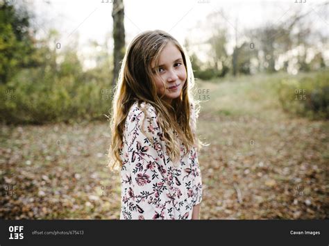 Portrait Of Confident Girl Standing At Park Stock Photo