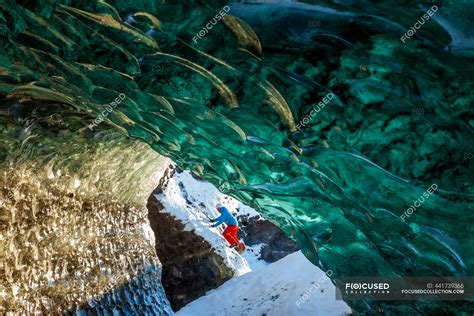 Person Exploring A Glacial Ice Cave On The Svinafellsjokull Glacier