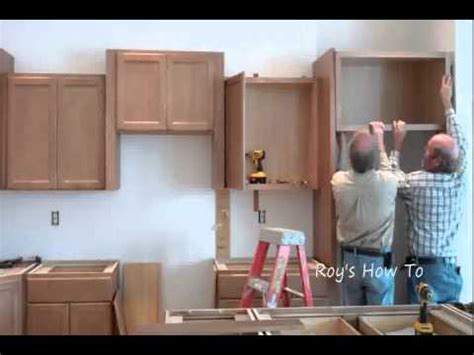 Use a level to ensure your cabinets are installed accurately. Installing Kitchen Cabinets - YouTube