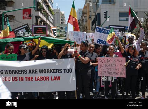 beirut lebanon 5th may 2019 protesters are seen holding a banner flags and placards during