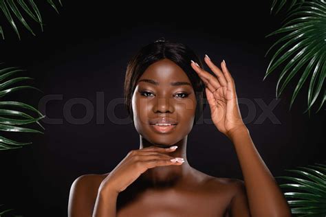 African American Naked Woman Touching Face Near Green Palm Leaves