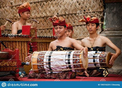 Group Of Balinese Men In Traditional Costumes Play Gamelan Music
