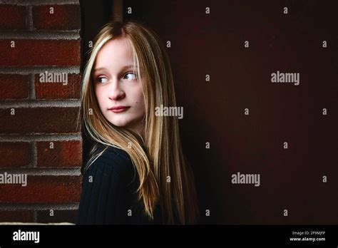 Beautiful Tween Girl With Blond Hair Looking Thoughtful Stock Photo Alamy